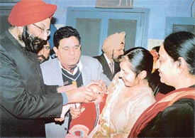 Dr A.S. Chawla and Dr Nelam Bassi administer polio drops to a child at Canal Dispensary