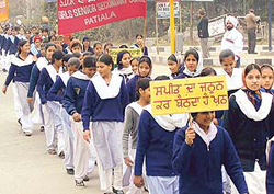 Schoolchildren lead a procession to spread awareness on road safety 