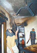 A houseowner shows damage by gas fire 