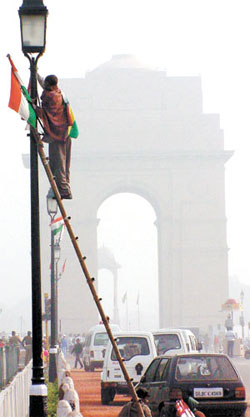 Workers giving final touches to a lamp-post at Rajpath for the Republic Day parade in the Capital