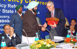 Punjab Chief Minister Amarinder Singh presents a memento to Dr Roger Noll