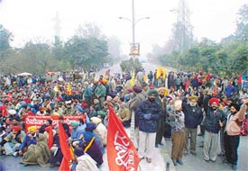 Members of employees� unions block traffic on the Ferozepore Road in front of Gate 1 of Punjab Agricultural University