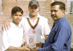 Brijesh Kumar presenting the Man of the Match Award to Robin Raj and Rocky at the Freedom Cup Cricket Tournament