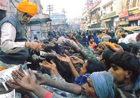 So many hands trying to reach out for the parsad being distributed on the occasion of the birth anniversary celebrations of Guru Gobind Singh