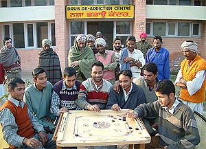 Drug addicts play carom at a de-addiction centre