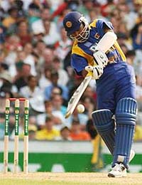 Sri Lanka's Marvan Atapattu reaches his century by hitting a four
