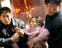 Chinese workers escape a fire at an eyeglass factory