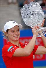 Belgium's Kim Clijsters holds her trophy after winning the women's final