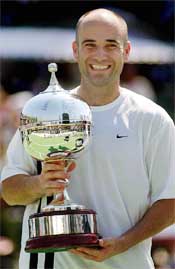 American Andre Agassi holds the winners trophy after defeating Sebastien Grosjean of France in the final 