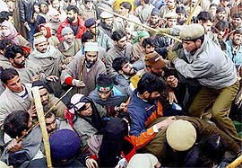 Policemen try to control people during a public meeting