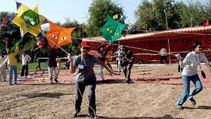 Young girls busy flying kites during a kite festival