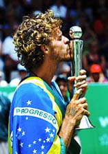 Gustavo Kuerten of Brazil kisses his trophy