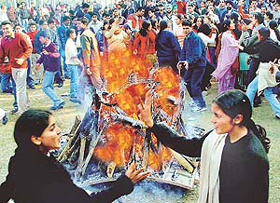Students dance around a bonfire during Lohri celebrations on the Panjab University campus