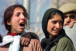 Unidentified relatives of Shabbir Ahmad Wani mourn during his funeral