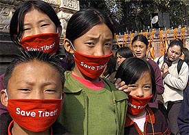 Tibetan monks with "Save Tibet" band during their Kalchakra mass initiation programme
