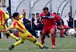Bhutan's Ramesh Budathoki clears an attack by Sonam Tobgye of Nepal