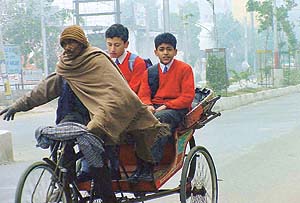 Children on their way to school in a rickshaw