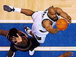 Minnesota Timberwolves' forward Gary Trent shoots the ball around the defense of Denver Nuggets' forward Donnell