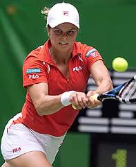 Kim Clijsters of Belgium returns to Samantha Reeves of the United States