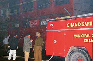 Fire engines engaged in dousing fire in the Haryana State Cooperative, Agriculture and Rural Development Bank Limited building in Sector 22 in Chandigarh on Wednesday.