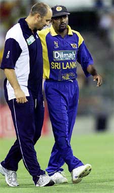 Sri Lanka�s Muttiah Muralitharan is helped from the field