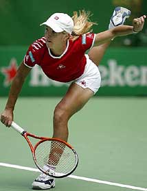 Justine Henin-Hardenne serves during her second-round match against Anna Kournikova