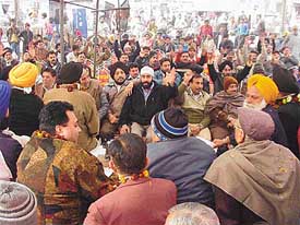 Shopkeepers of Luxmi Market and prominent political leaders sit on a chain fast