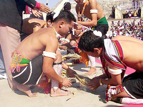 Zelianrong youths extracting what they call "Holy Fire" from bamboo split