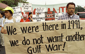 Filipinos who have worked overseas hold a banner in front of the US embassy