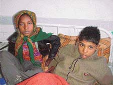Nandini and Narayan wait for their parents at the Ludhiana Civil Hospital after they were brought there by the police