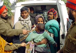 Bangladeshi nationals are escorted by police officials in the Khem Karn sector