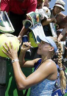 Anna Kournikova from Russia signs her autograph for fans