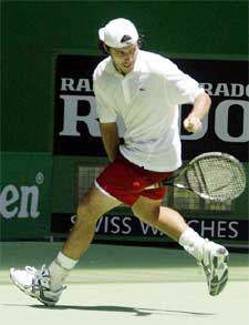 Sebastien Grosjean from France hits a shot from between his legs