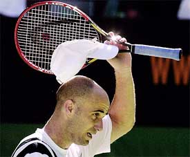 Andre Agassi of the United States takes off his hat after winning his third round match against Nicolas Escude 