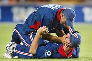 England captain Nasser Hussain jumps on teammate Ian Blackwell after Blackwell took a catch 