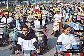 Students participate in the Save Oil Two-Weeler Women�s Rally-2003 that was flagged off from Panjab University