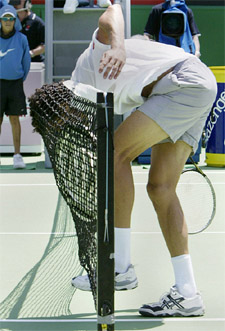 Younes El Aynaoui of Morocco puts his head to the net after making a volley to Feliciano Lopez of Spain during their match at the Australian Open