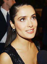 Actress Salma Hayek talks to a reporter as she arrives at the Eighth Annual Critics�