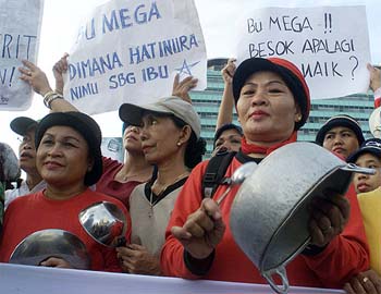 Housewives hit pots and pans during a price hike protest
