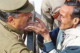 A BJP supporter pleads with the police to stop casting of fake votes in ward no. 13