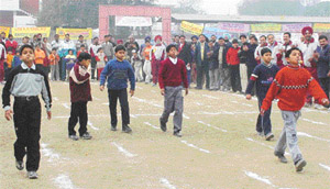 Children participate in the spoon-potato race in the Lions Olympic Games-2003