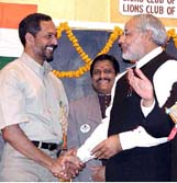 Gujarat Chief Minister Narendra Modi being greeted by film star Nana Patekar