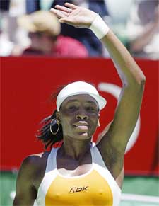 Venus Williams of the USA waves after defeating Nicole Pratt of Australia at the Australian Open