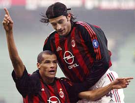 A.C. Milan's midfielder Rivaldo celebrates with his team-mate Kakha Kaladze