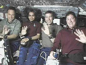 Israeli astronaut Ilan Ramon, astronaut Kalpana Chawla, Commander Rick Husband and astronaut Laurel Clark wave to the camera
