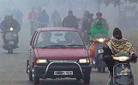Dense fog forces vehicles to move at a snail�s pace in Chandigarh on Monday morning