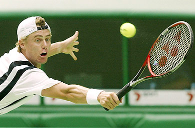 Lleyton Hewitt of Australia reaches for a backhand return