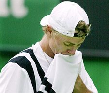 Lleyton Hewitt of Australia wipes his face during his loss to Younes El Aynaoui of Morocco
