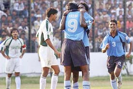 Indian striker Abhishek Yadav is embraced by his teammate
