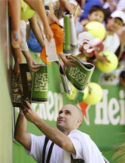Andre Agassi of the USA signs autographs